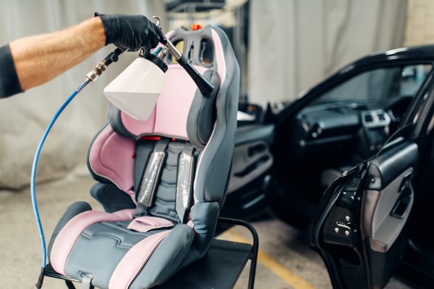 carwash-removing-dust-dirt-from-child-seat_266732-7457
